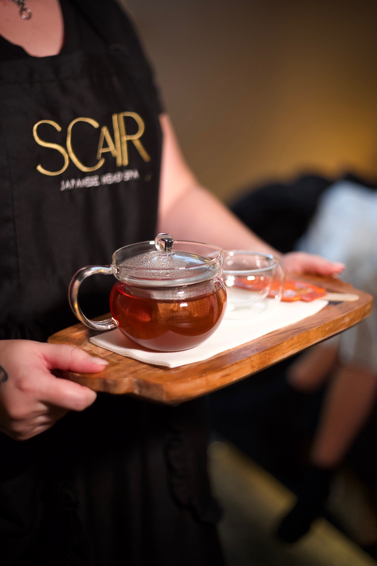 Signature tea service in a SCaIR branded apron
